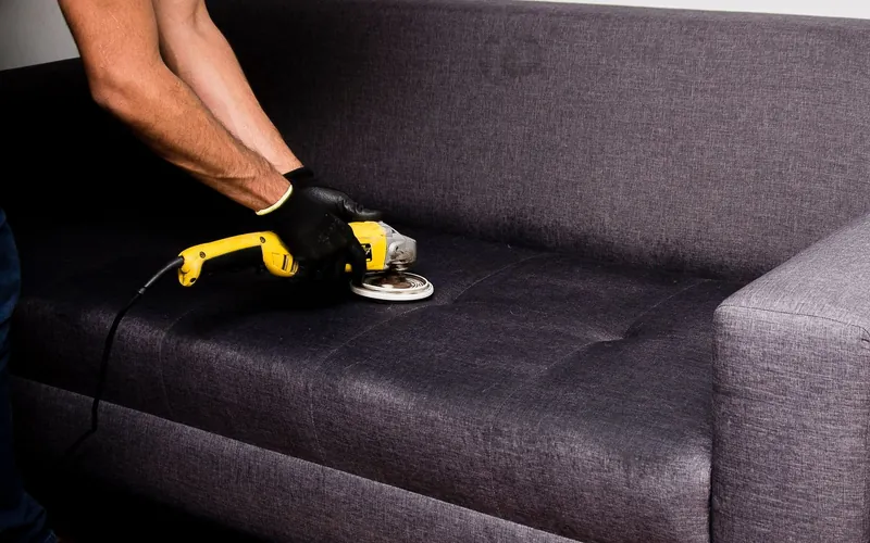 Technician deep cleaning commercial upholstery with an extraction machine