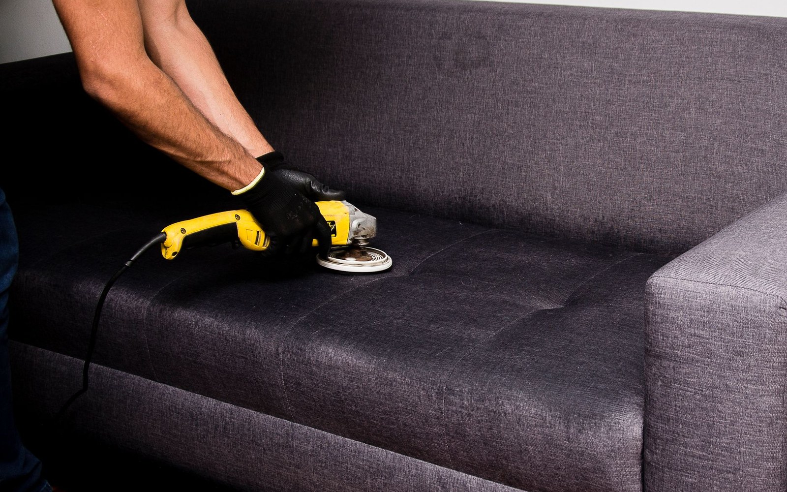 Technician deep cleaning commercial upholstery with an extraction machine