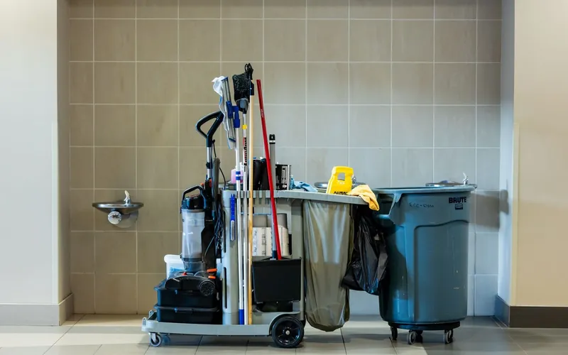 Professional janitorial cart stocked with supplies inside a commercial building