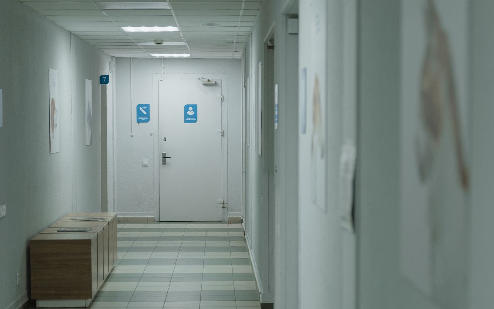 Quiet, spotless medical facility hallway held to clinical cleaning standards