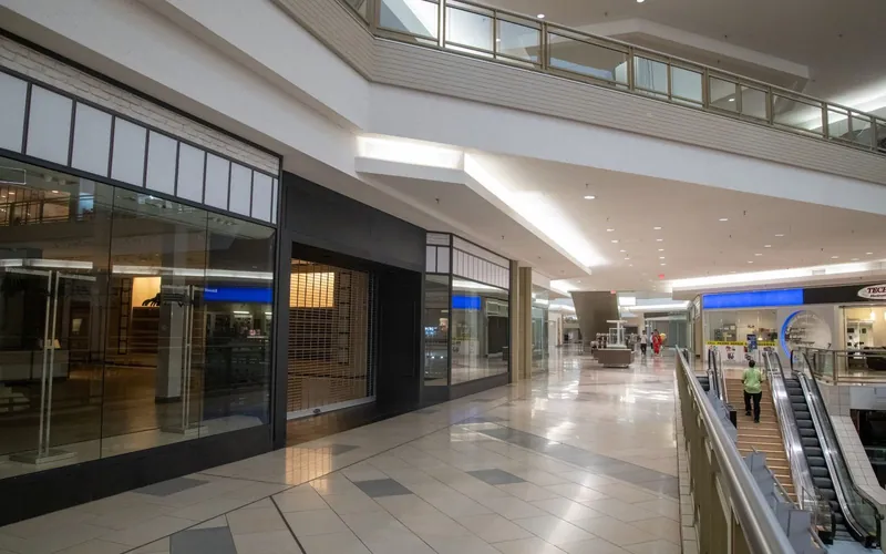 Polished retail corridor with gleaming floors and clean storefront glass