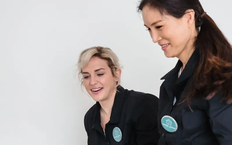 Smiling members of the Maria Andrade commercial cleaning team in uniform